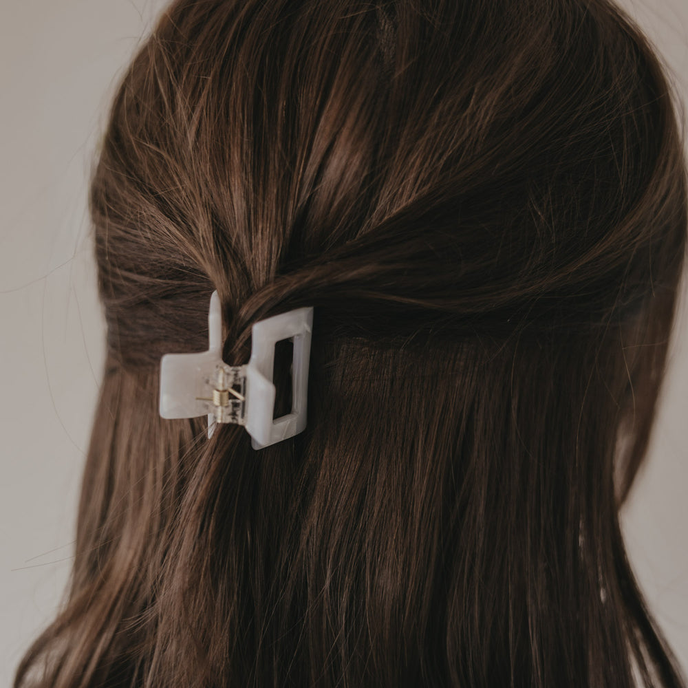 Detail der kleinen eckigen Haarspange in Perlmutt-Optik im Haar