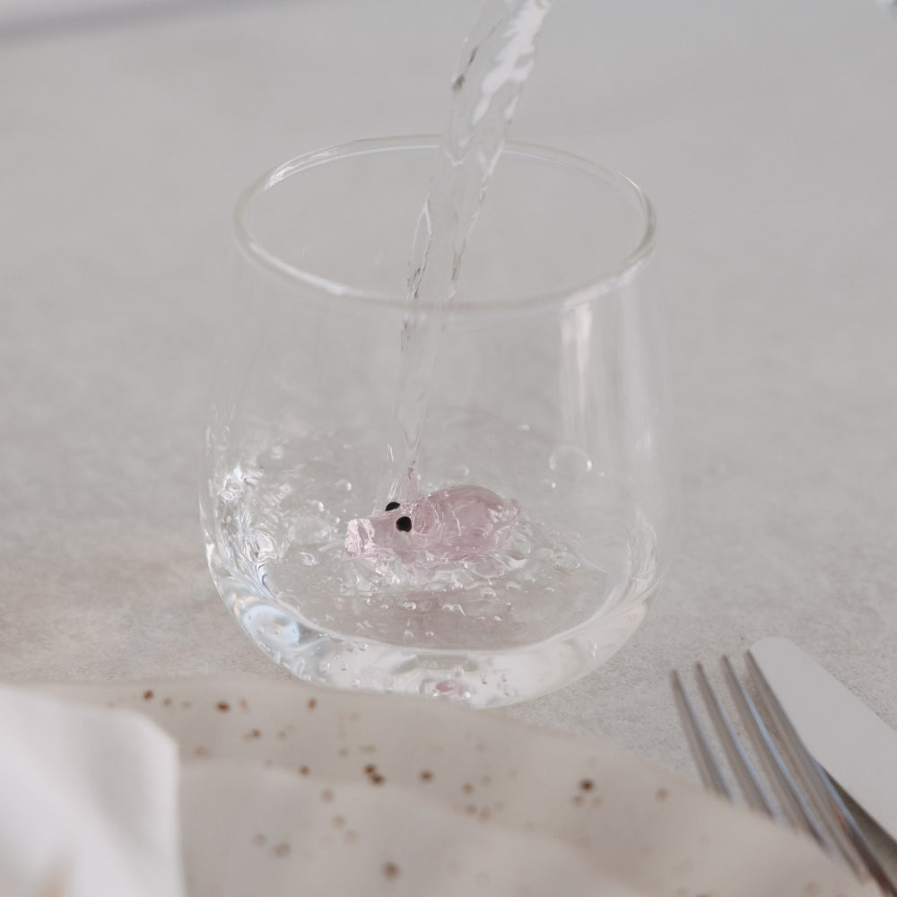 Wasser wird in Glas mit Schwein-Figur gefüllt, doppelwandiges Design für besondere Optik