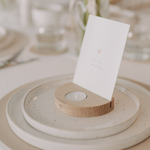 Holz-Teelichthalter mit Karte auf Keramiktellern dekoriert, gezeigt in harmonischer Tischszene.