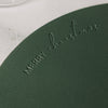 Detail des dunkelgrünen Platzsets mit geprägtem Merry-Christmas-Schriftzug