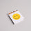 Geöffnete Streichholzschachtel mit gelbem Smiley und bunten Streichhölzern im Inneren.
