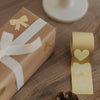 Geschenk mit weißem Band und goldenen Aufklebern Stern und Schleife zur Dekoration