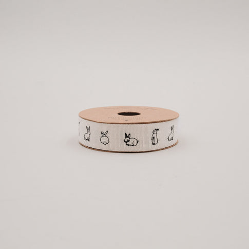 Seitliche Ansicht der Geschenkbandrolle mit Kaninchenillustrationen auf weißem Band.